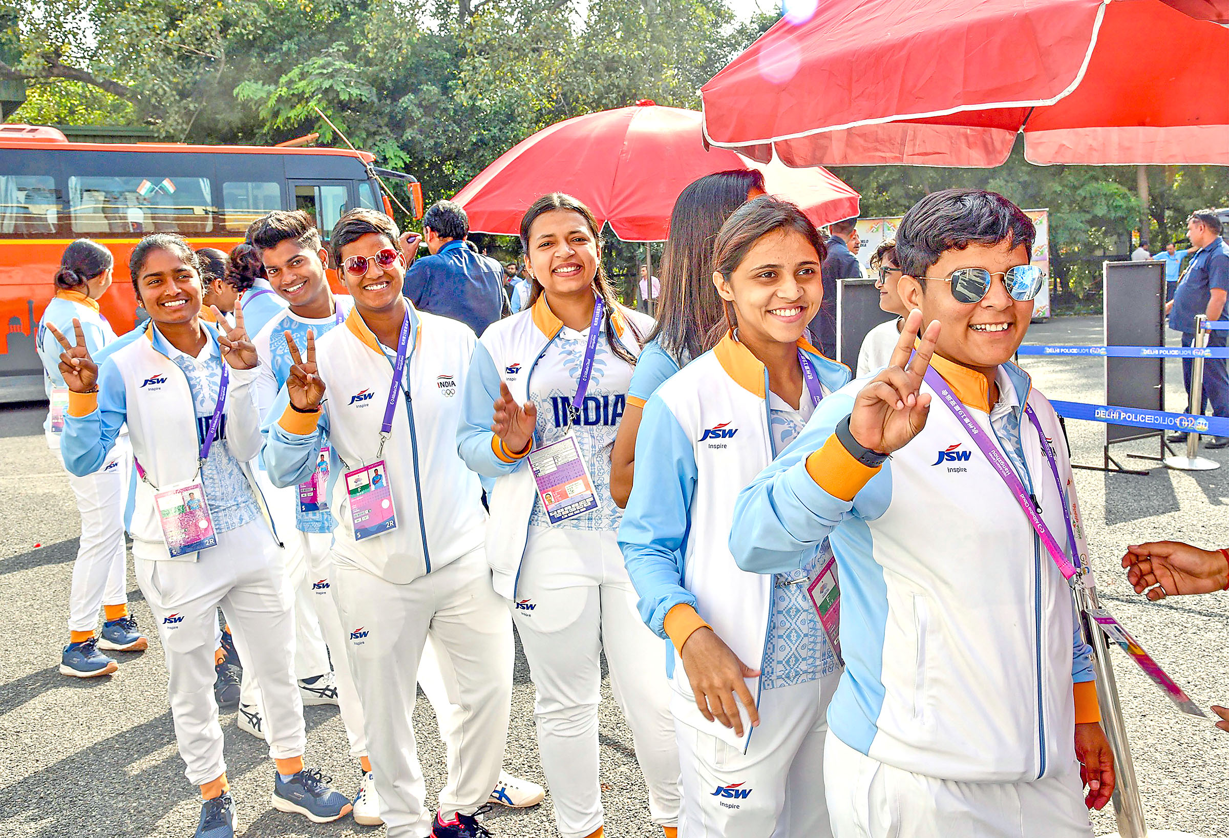Women players show victory sign as they reach venue to meet PM Modi.