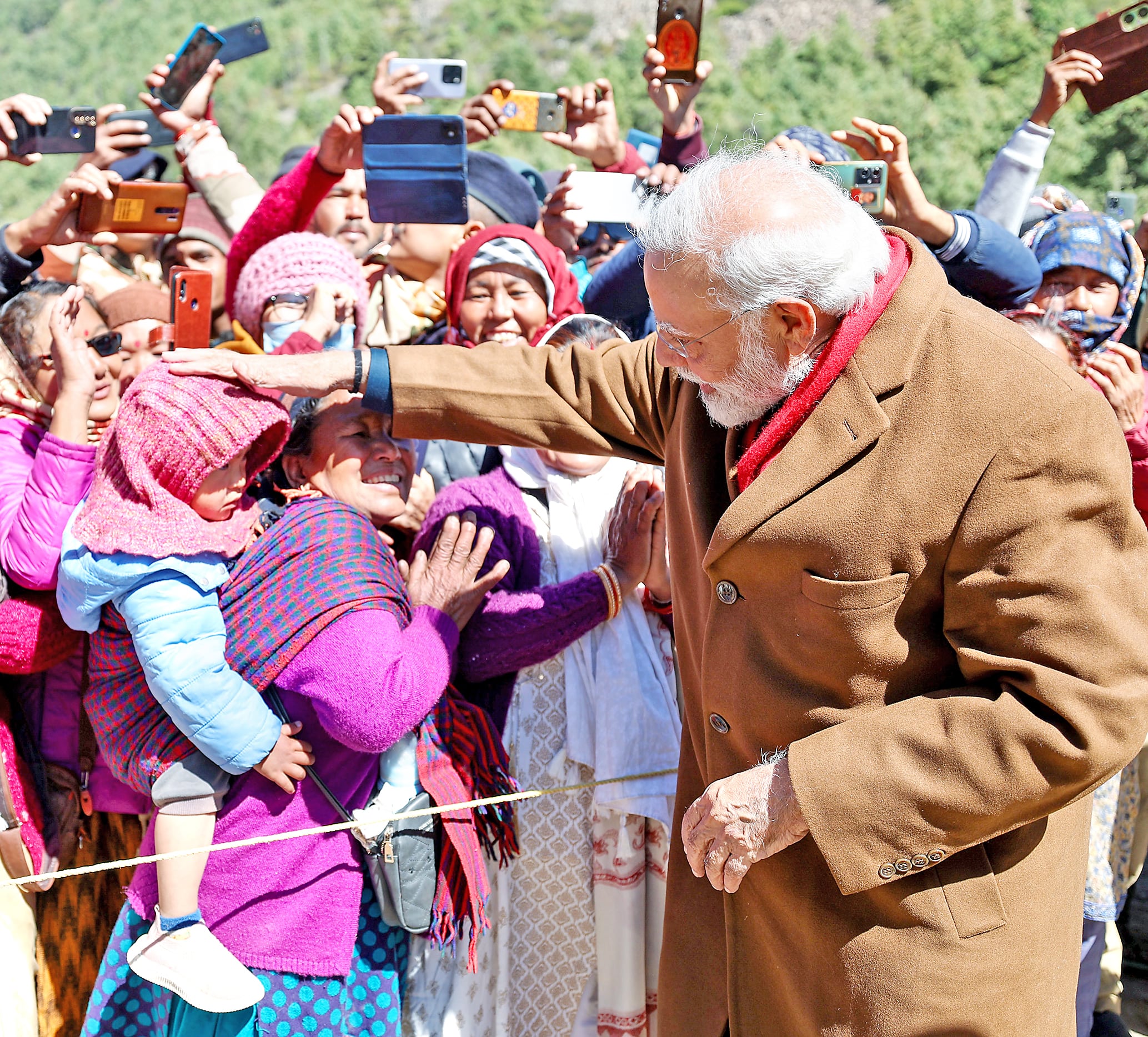 PM Narendra Modi pampers a child during his visit to Gunji Village in Pithoragarh.
