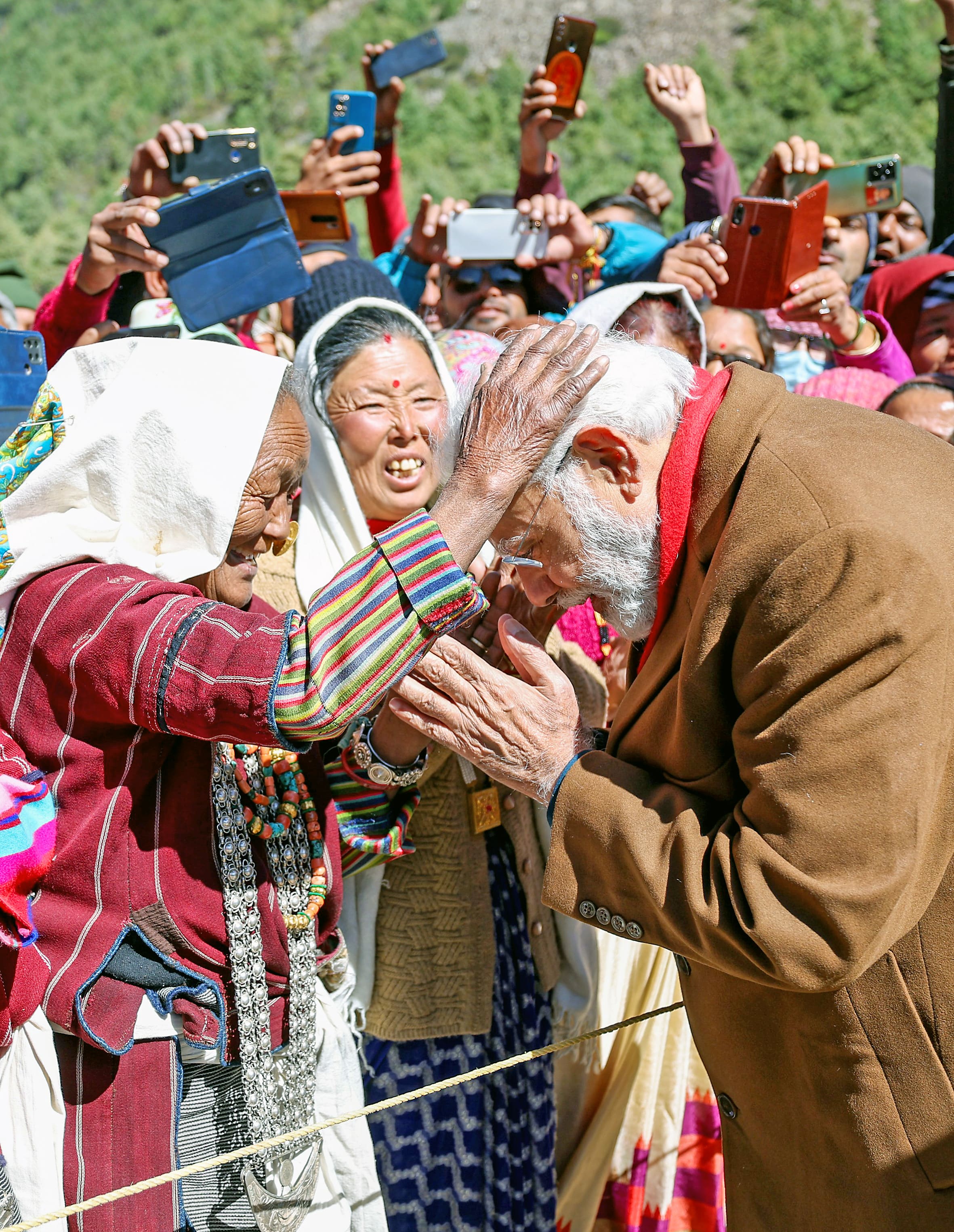 Prime Minister Narendra Modi seeks blessings of an elderly woman during his visit to Gunji Village.