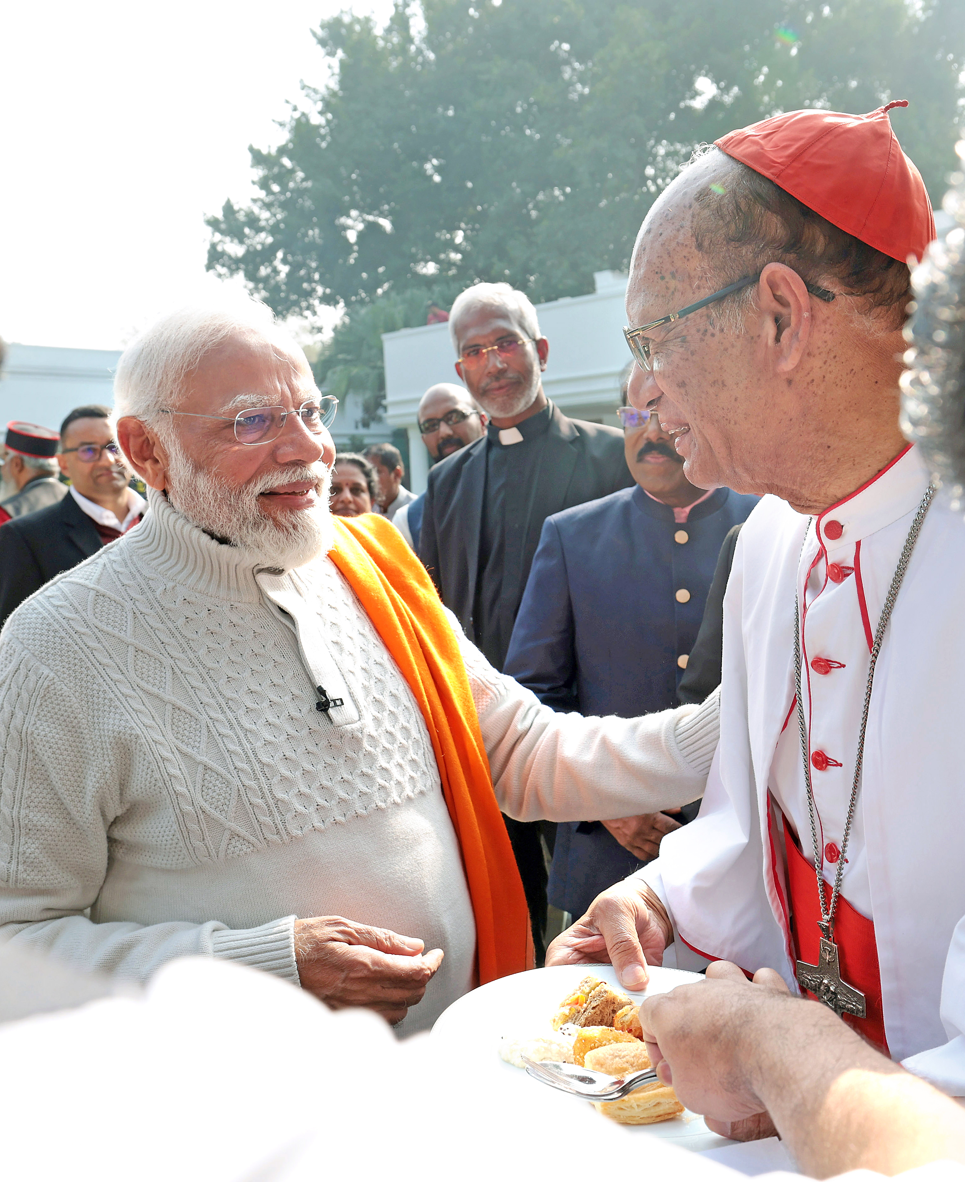 PM Narendra Modi greets a priest.