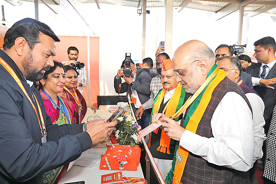 Amit Shah gets his pass scanned at the registration counter.