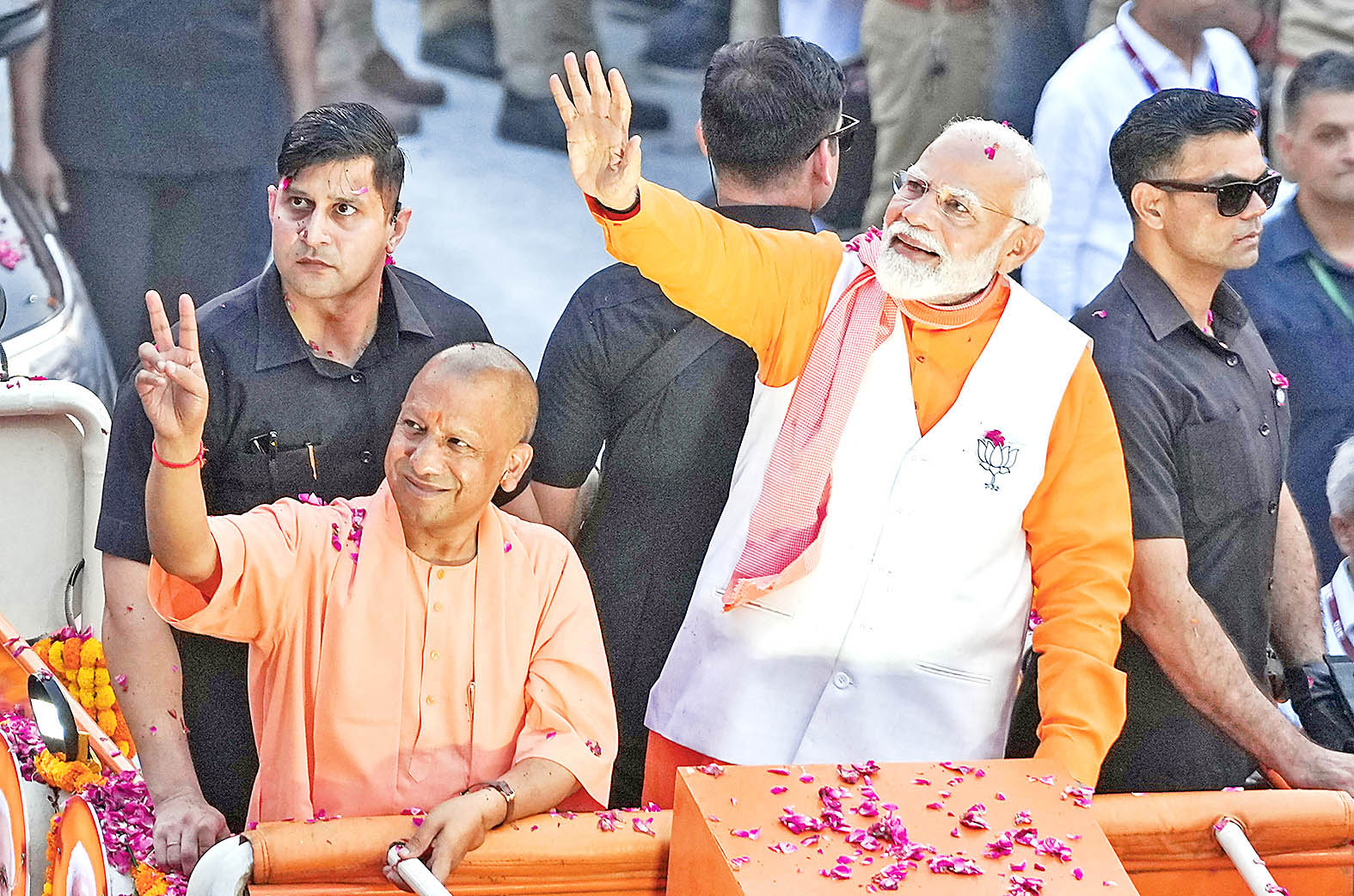 Modi and Yogi wave supporters.